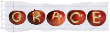 a piece of notebook paper with apples carved to spell out 'grace'